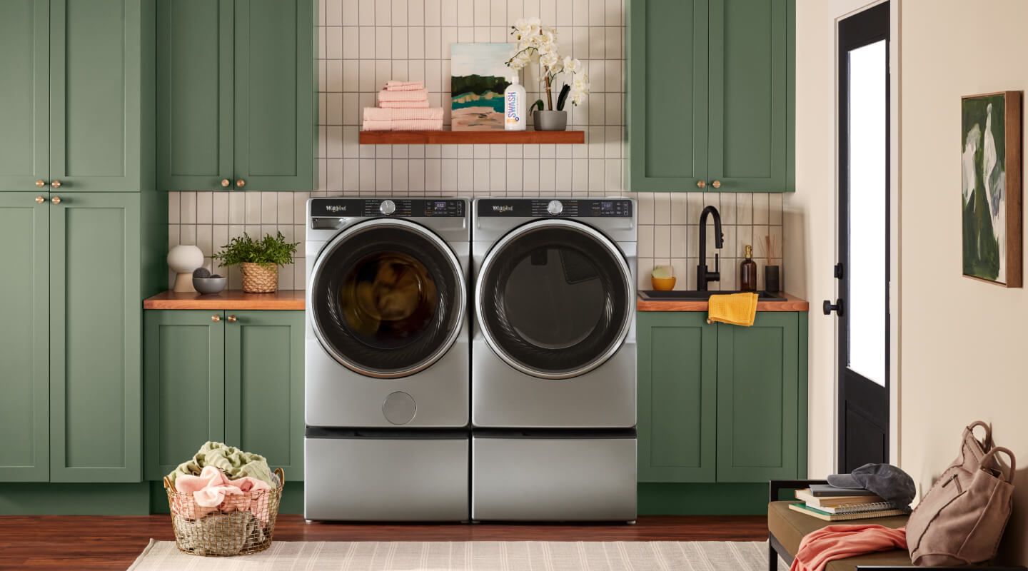 A laundry area with a Whirlpool® Smart Front Load Washer and Dryer pair