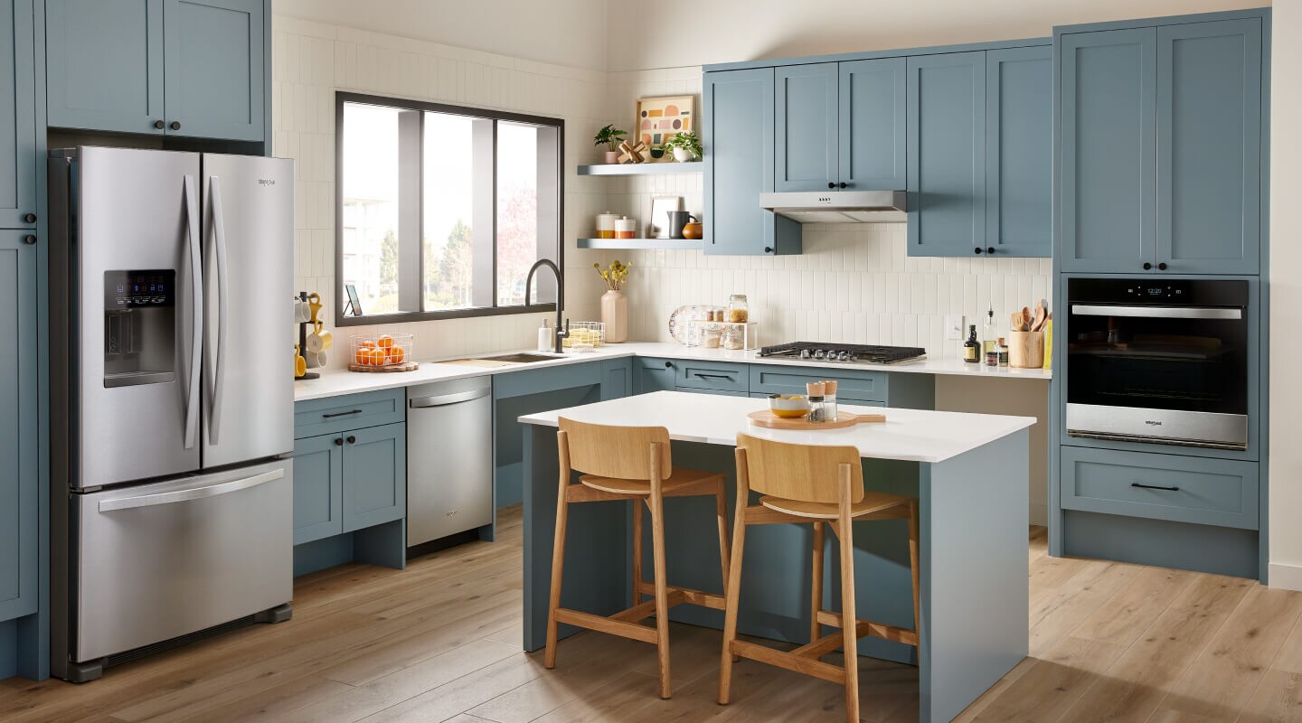 Stainless steel appliances in a blue kitchen Stainless steel appliances in a blue kitchen