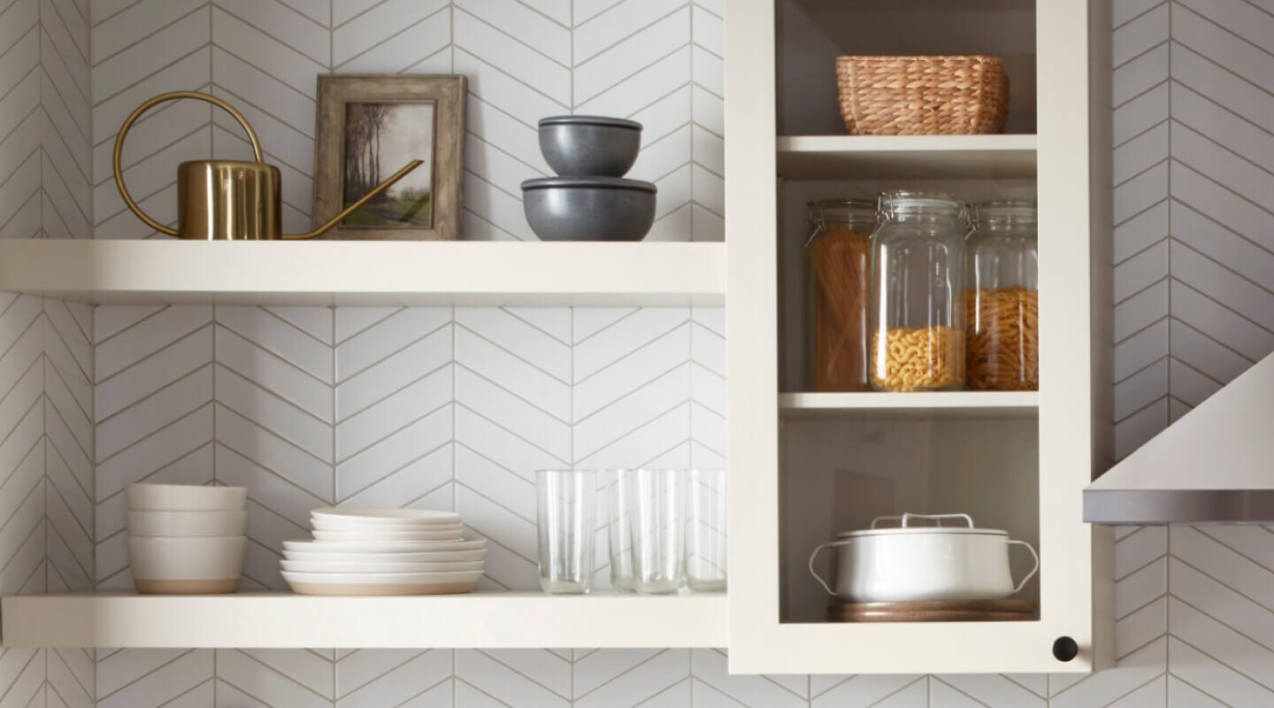 White shelves filled with dishes and glassware White shelves filled with dishes and glassware