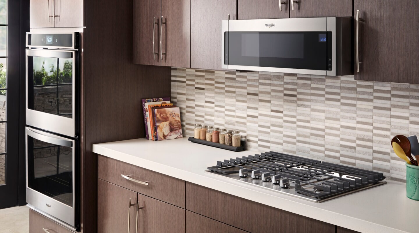 Whirlpool® gas cooktop in front of gray and white tile backsplash Whirlpool® gas cooktop in front of gray and white tile backsplash