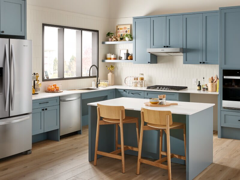 Stainless steel appliances in a blue kitchen Stainless steel appliances in a blue kitchen