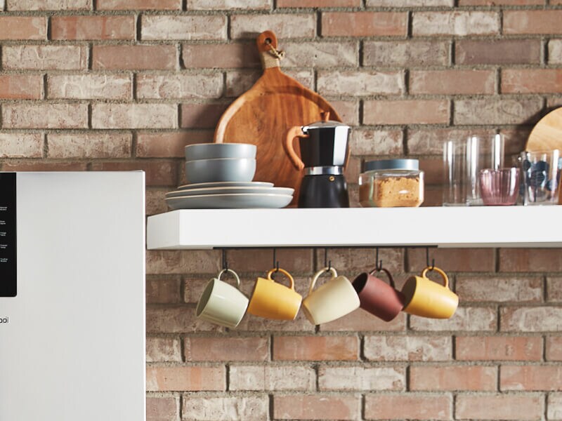 White shelves filled with mugs and coffee accessories White shelves filled with mugs and coffee accessories