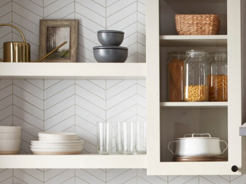 White shelves filled with dishes and glassware White shelves filled with dishes and glassware