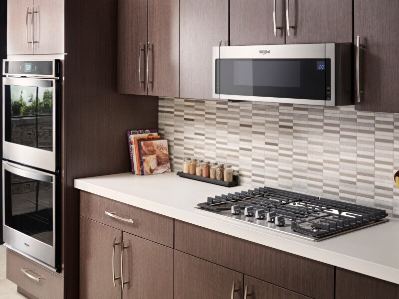 Whirlpool® gas cooktop in front of gray and white tile backsplash Whirlpool® gas cooktop in front of gray and white tile backsplash
