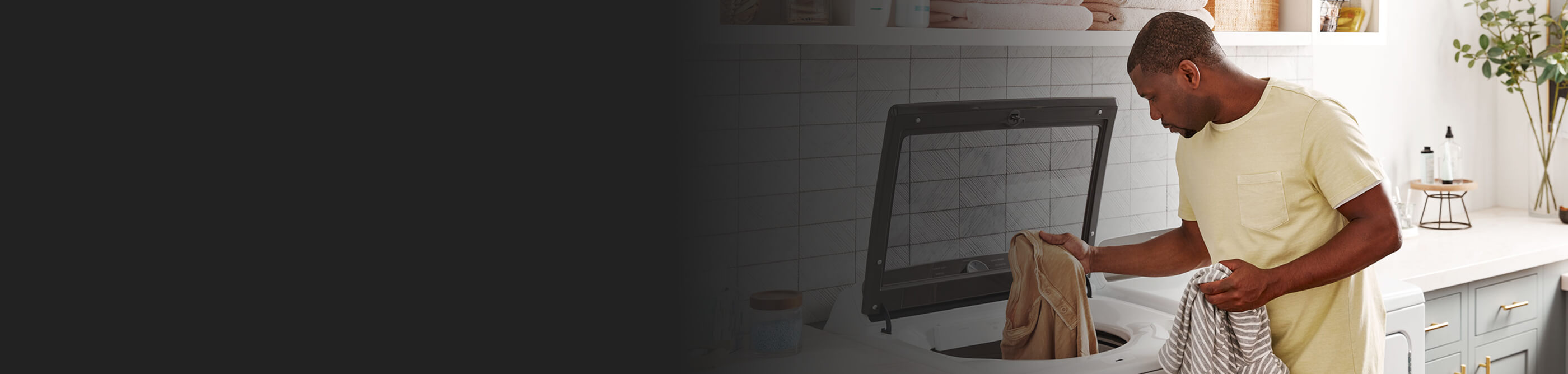 A person taking laundry out of a washer