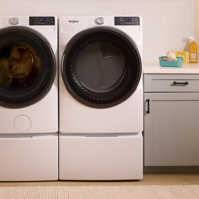 A Whirlpool® Front Load Dryer next to a Whirlpool® Front Load Washer