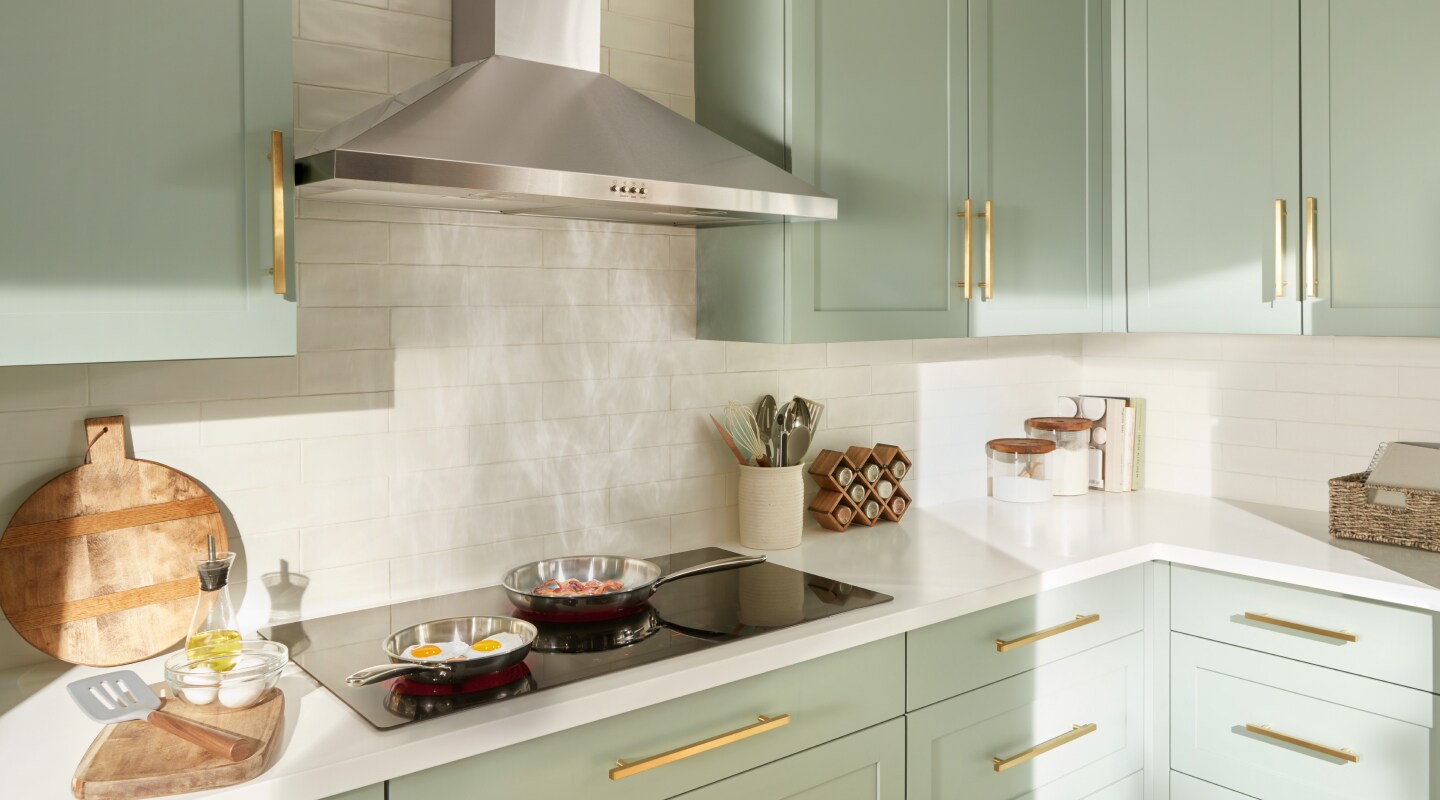 Eggs and bacon cooking under a range hood Eggs and bacon cooking under a range hood