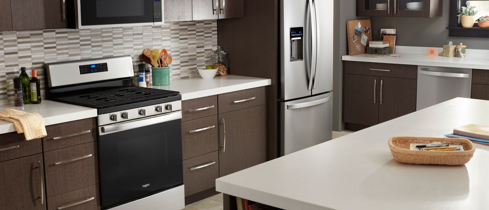 Stainless steel appliances in a kitchen with an island Stainless steel appliances in a kitchen with an island