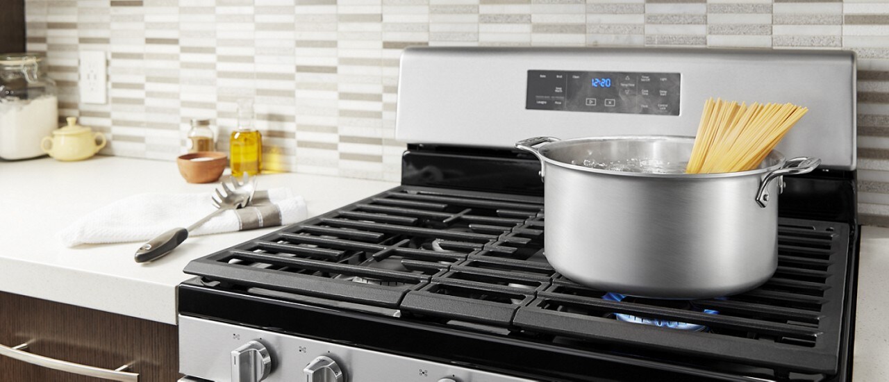 Spaghetti boiling on a gas stovetop Spaghetti boiling on a gas stovetop