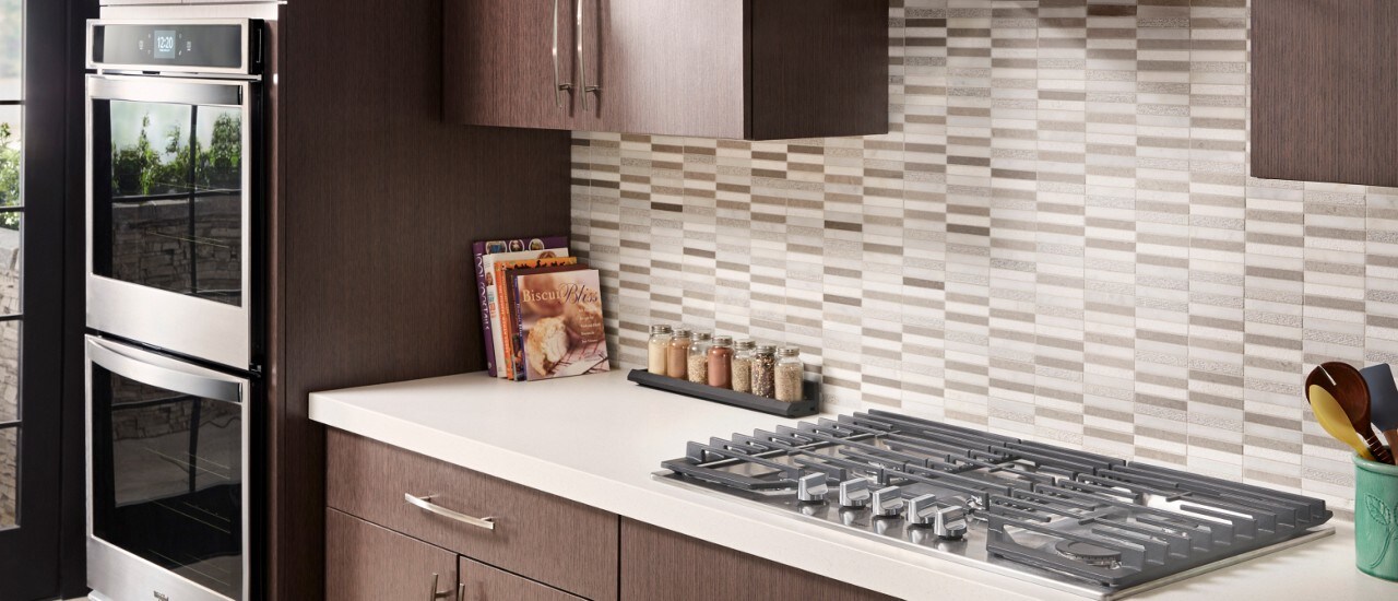 Gas cooktop and double wall oven in a kitchen Gas cooktop and double wall oven in a kitchen