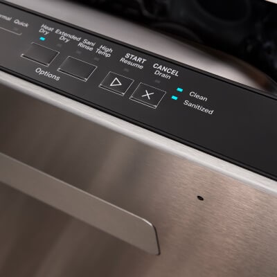 A top control panel on a dishwasher with blue lights on Clean, Sanitized and Heat Dry settings