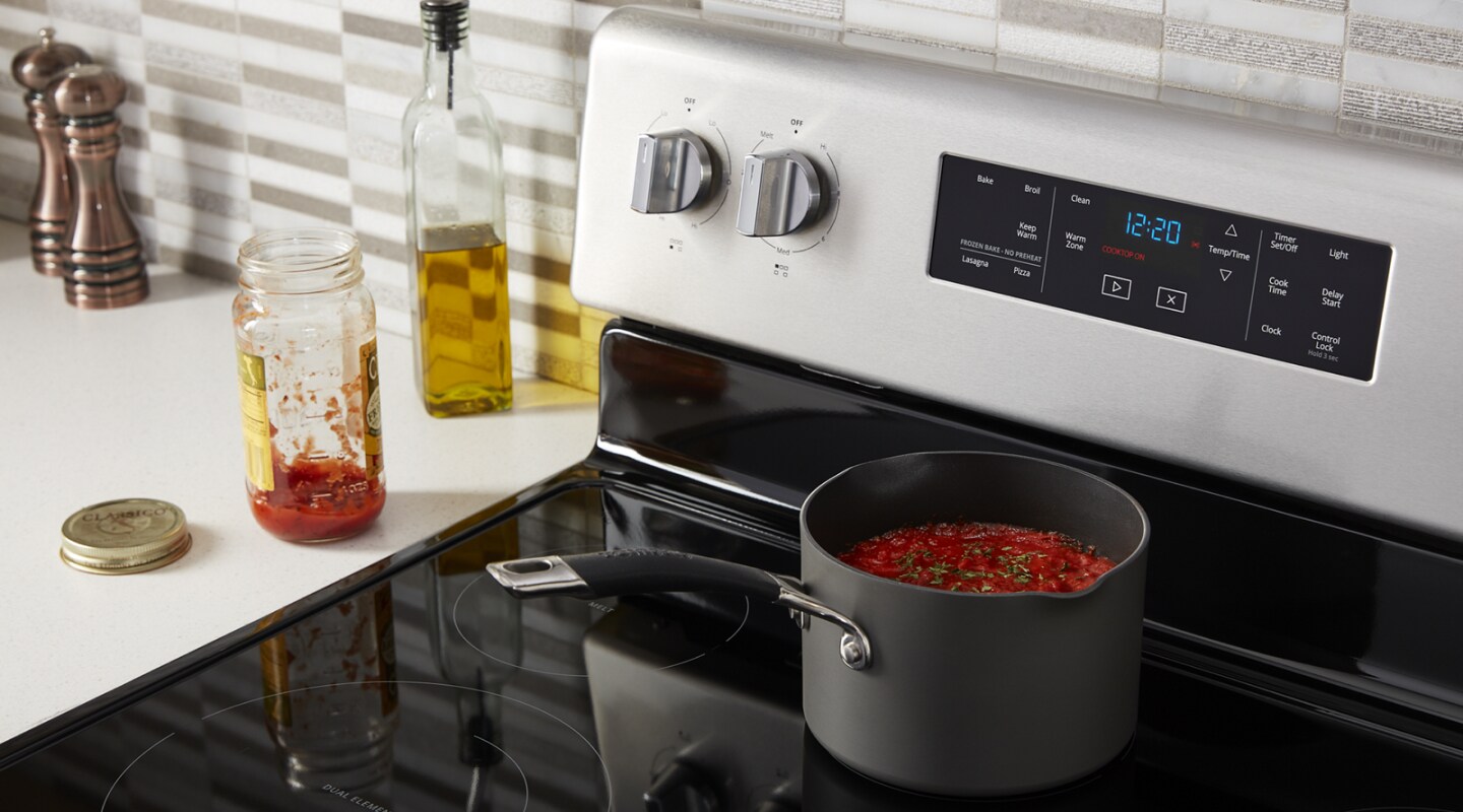 A pan of pasta simmering on a stove