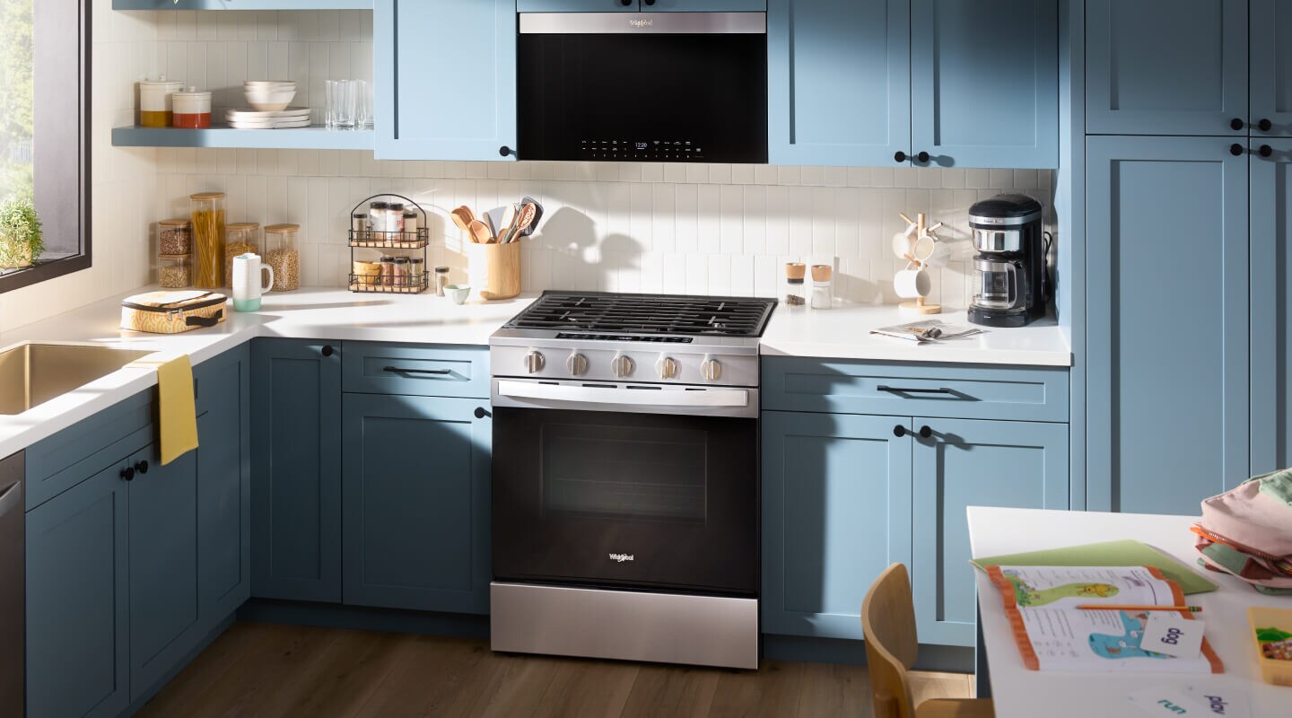 Kitchen with blue cabinetry and stainless steel Whirlpool® appliances Kitchen with blue cabinetry and stainless steel Whirlpool® appliances