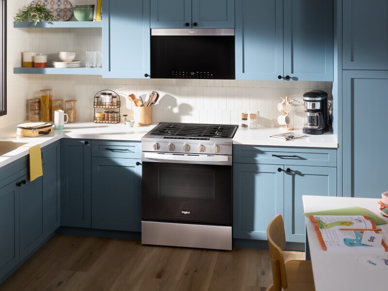 Kitchen with blue cabinetry and stainless steel Whirlpool® appliances Kitchen with blue cabinetry and stainless steel Whirlpool® appliances