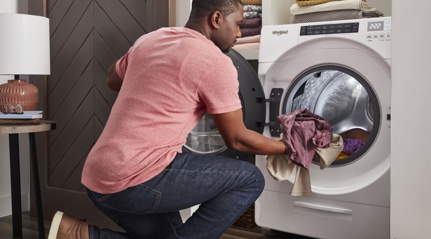 A person loading laundry into a Whirlpool® All-In-One Washer Dryer Combo A person loading laundry into a Whirlpool® All-In-One Washer Dryer Combo