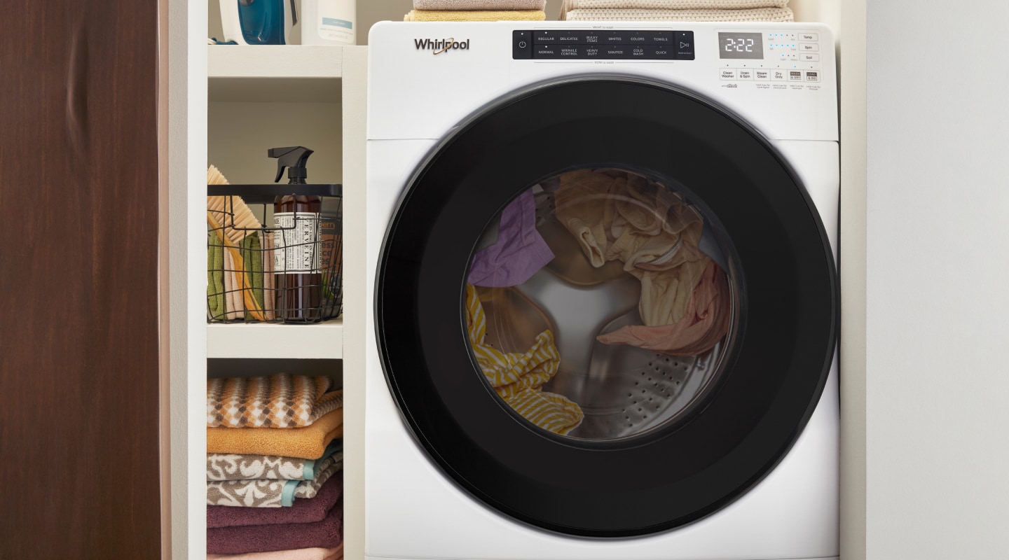 White washer dryer combo in a closet