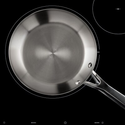 An overhead view of a pan on an induction cooktop