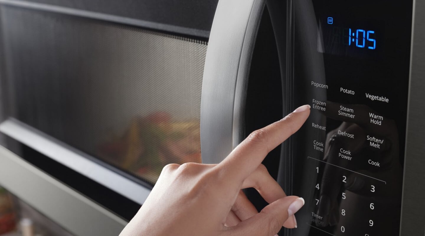 person operating a microwave person operating a microwave