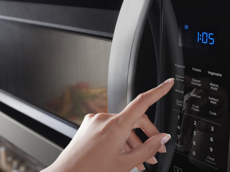 person operating a microwave person operating a microwave