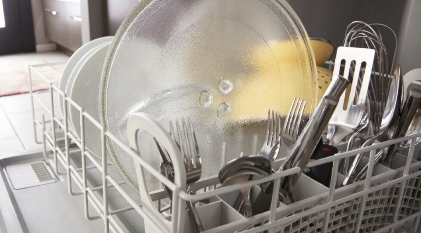 Dishes loaded in the lower rack of a dishwasher Dishes loaded in the lower rack of a dishwasher