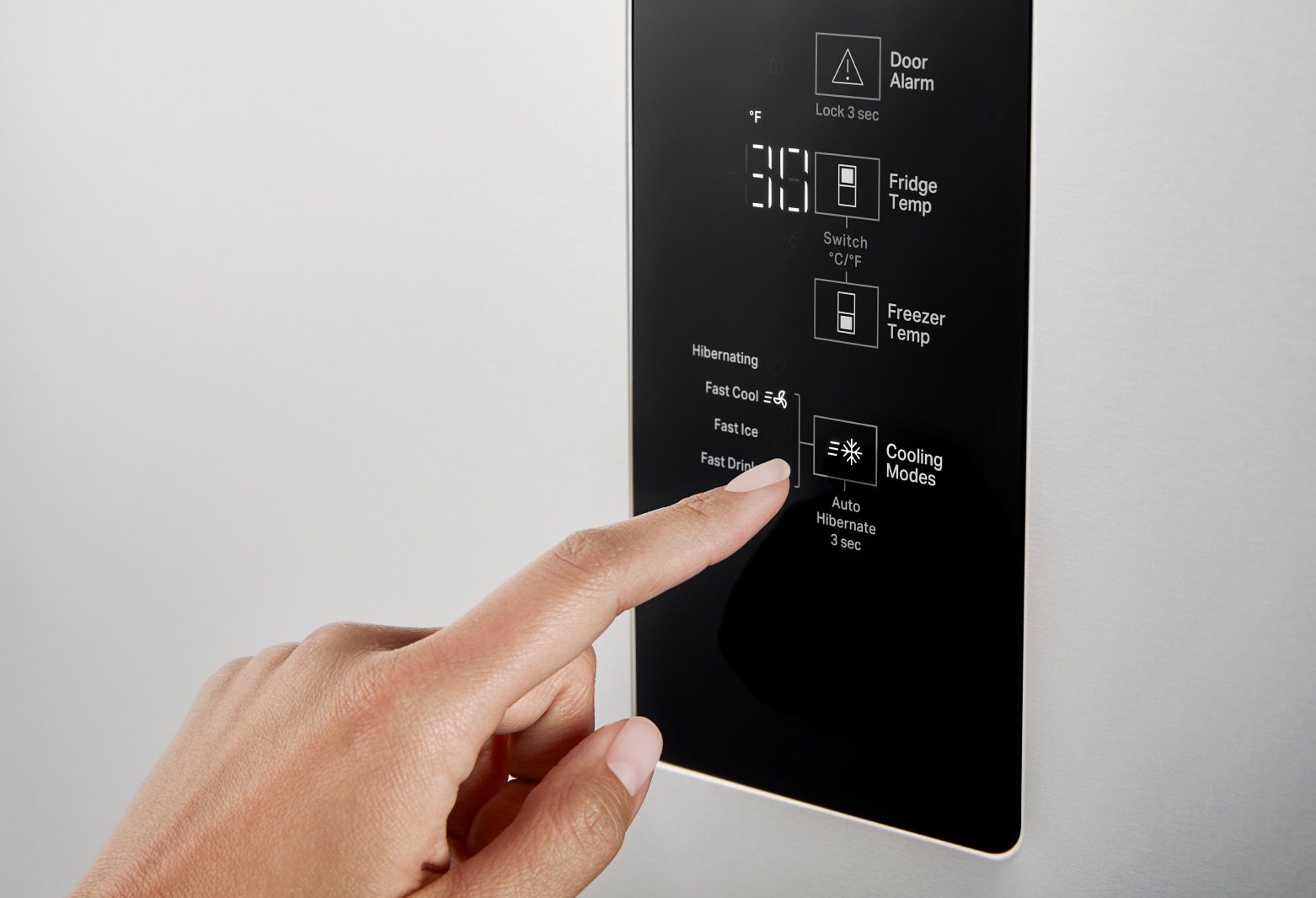 Close up shot of hand selecting cooling modes setting on freezer Close up shot of hand selecting cooling modes setting on freezer