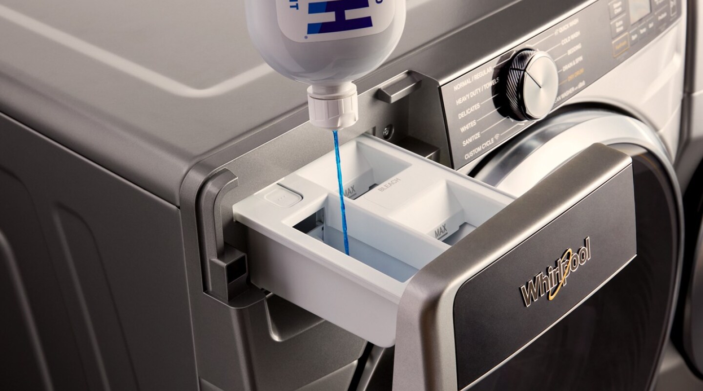 Blue HE detergent being poured into a washer