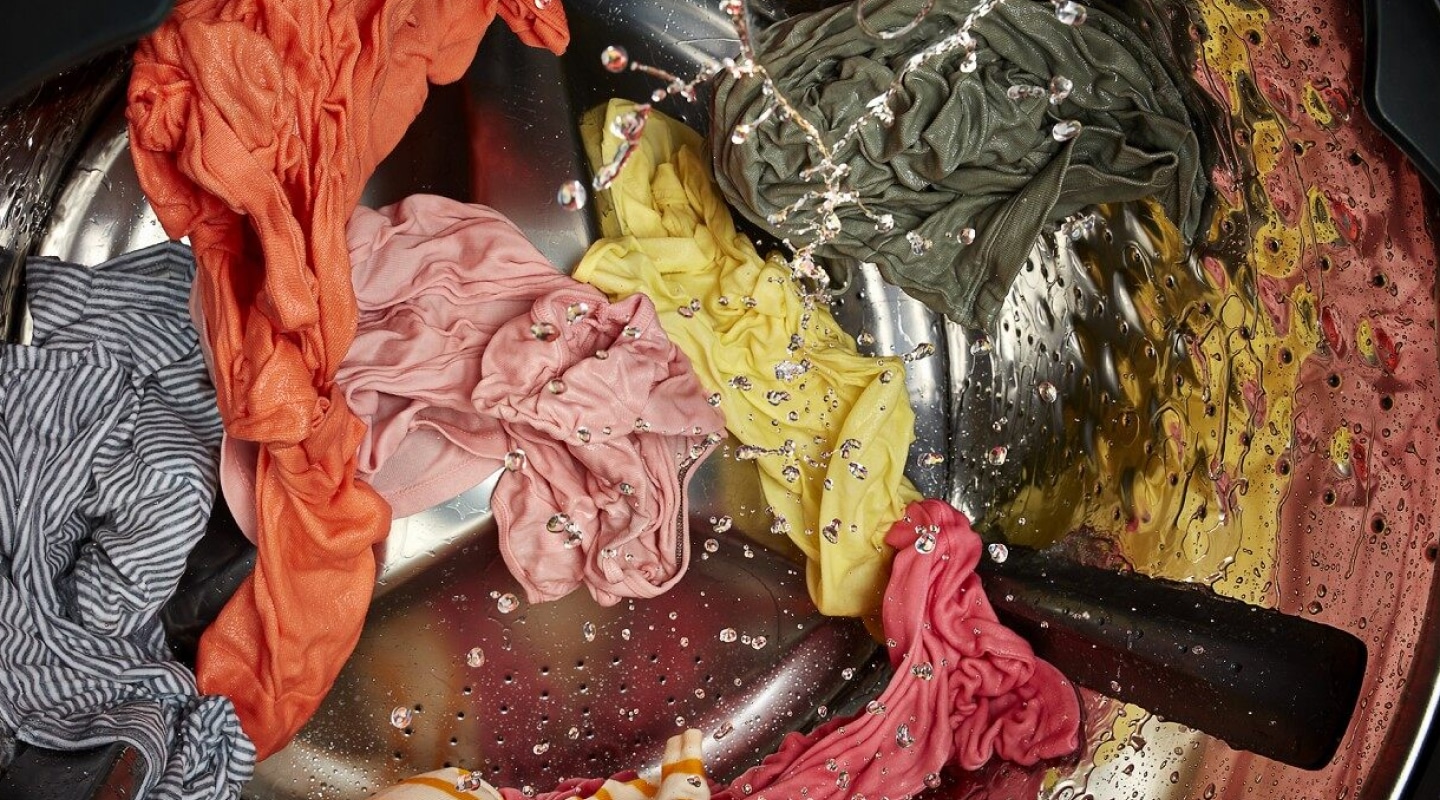 Colorful clothes soaking in a washer