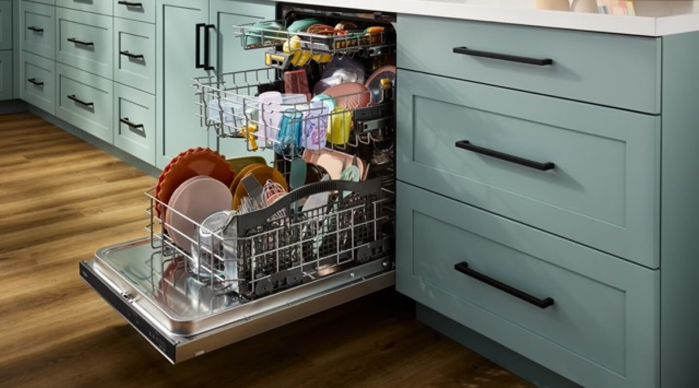 A dishwasher open with racks of clean dishes pulled out