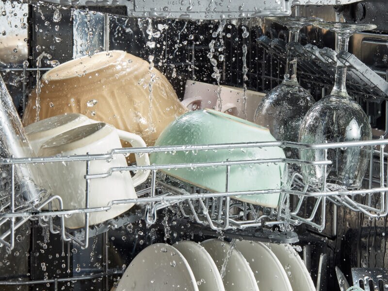 Water droplets falling on dishes in a dishwasher