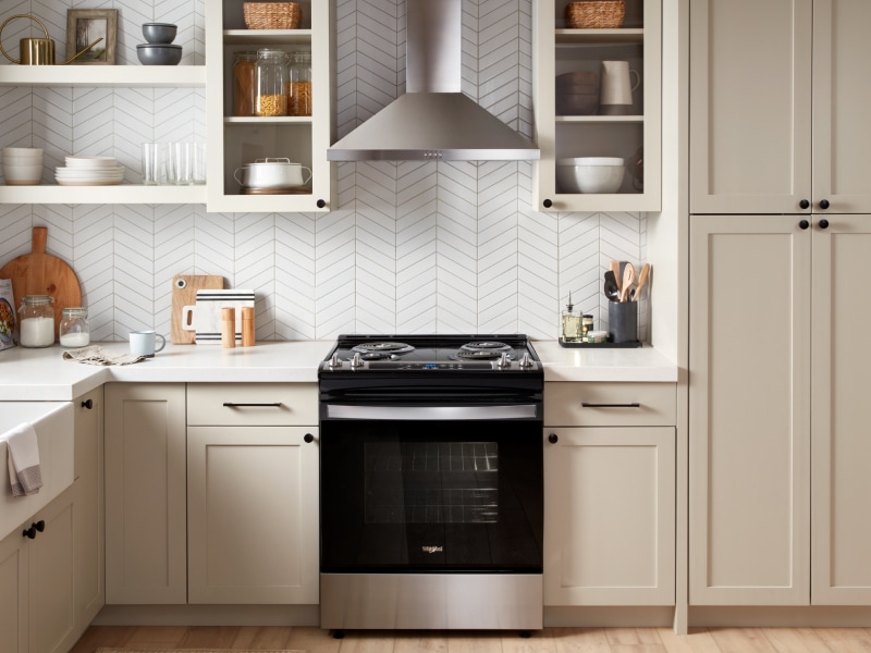 Stainless steel range hood above a Whirlpool® range Stainless steel range hood above a Whirlpool® range
