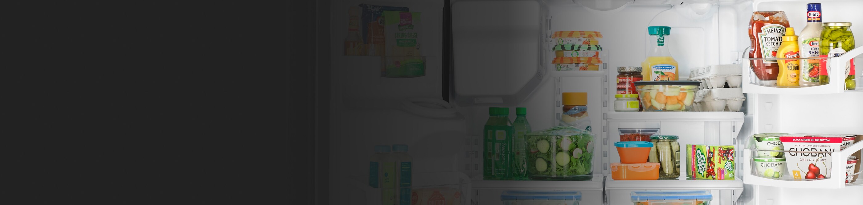 A Whirlpool® refrigerator loaded with a variety of foods