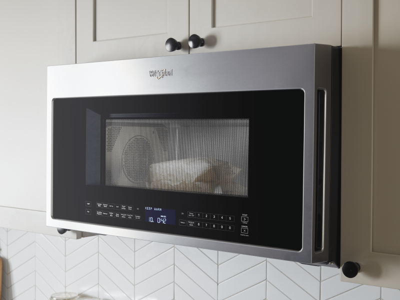 A Whirlpool® Over-The-Range Microwave in a modern kitchen. A Whirlpool® Over-The-Range Microwave in a modern kitchen.
