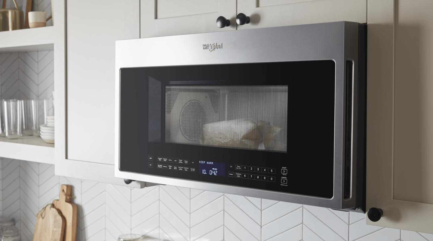 A Whirlpool® Over-The-Range Microwave in a modern kitchen. A Whirlpool® Over-The-Range Microwave in a modern kitchen.