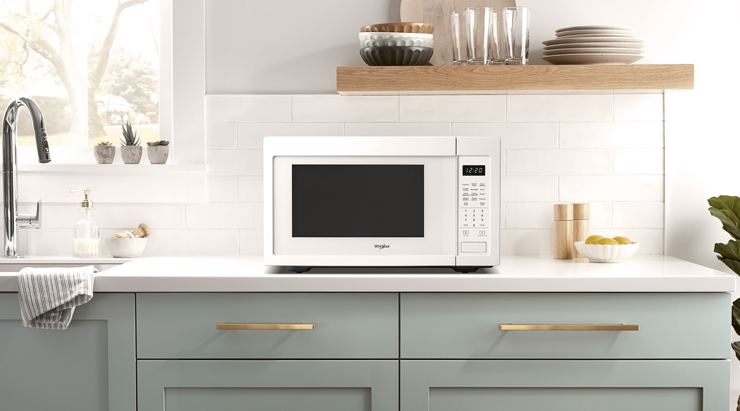 A Whirlpool® Countertop Microwave in a modern kitchen. A Whirlpool® Countertop Microwave in a modern kitchen.