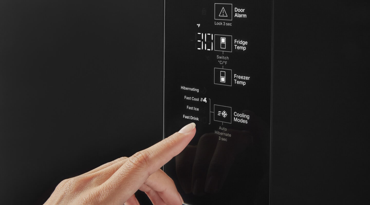 A person selecting the freezer temperature A person selecting the freezer temperature