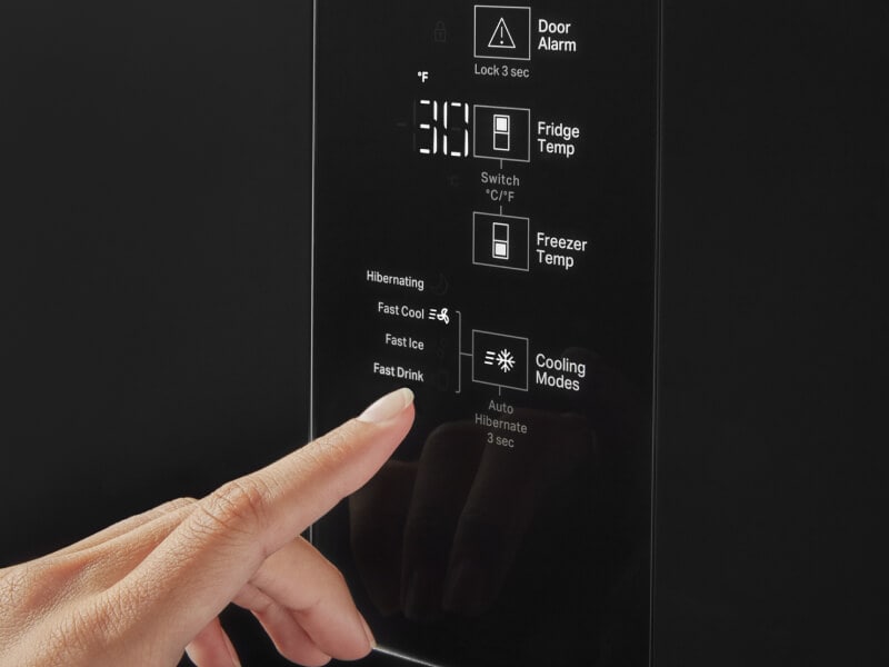 A person selecting the freezer temperature A person selecting the freezer temperature