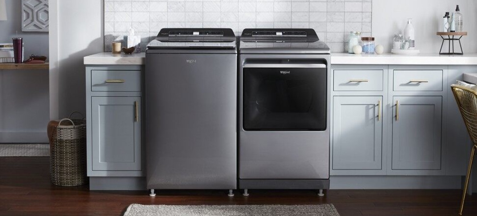 Top load smart washer and dryer in a bright laundry room Top load smart washer and dryer in a bright laundry room