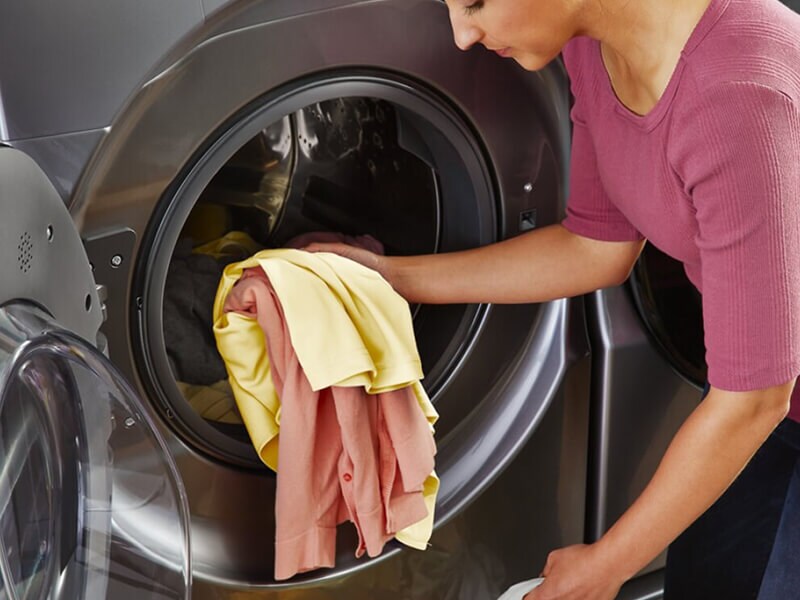 Person removing clothes from a dryer