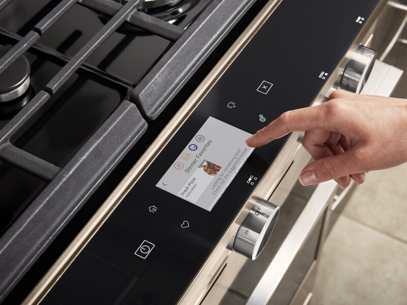 Person selecting touch screen settings on a gas oven Person selecting touch screen settings on a gas oven
