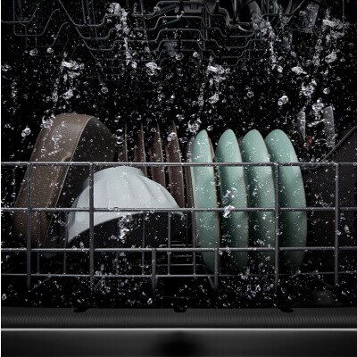 Dishes being washed inside a dishwasher