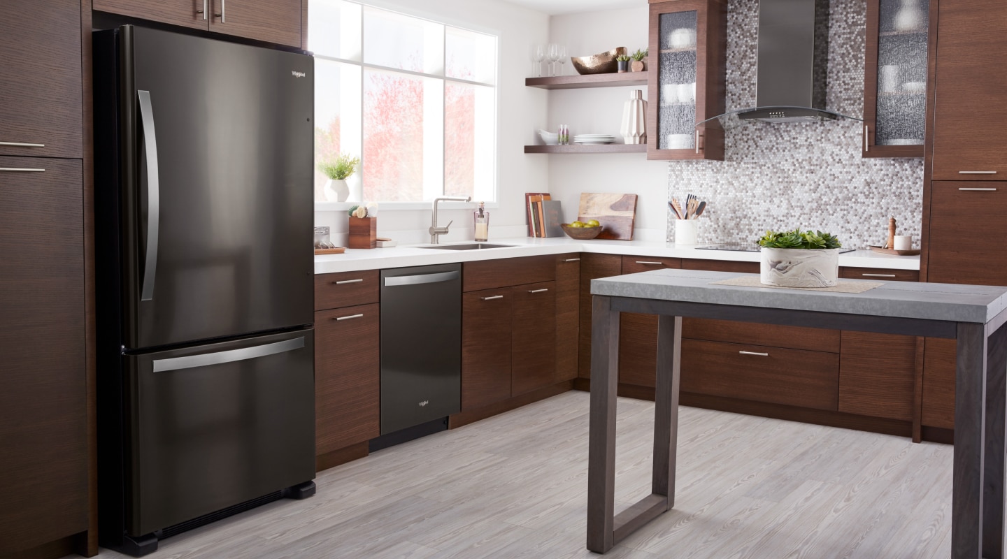 A black Whirlpool® Bottom-Freezer Refrigerator in a modern kitchen