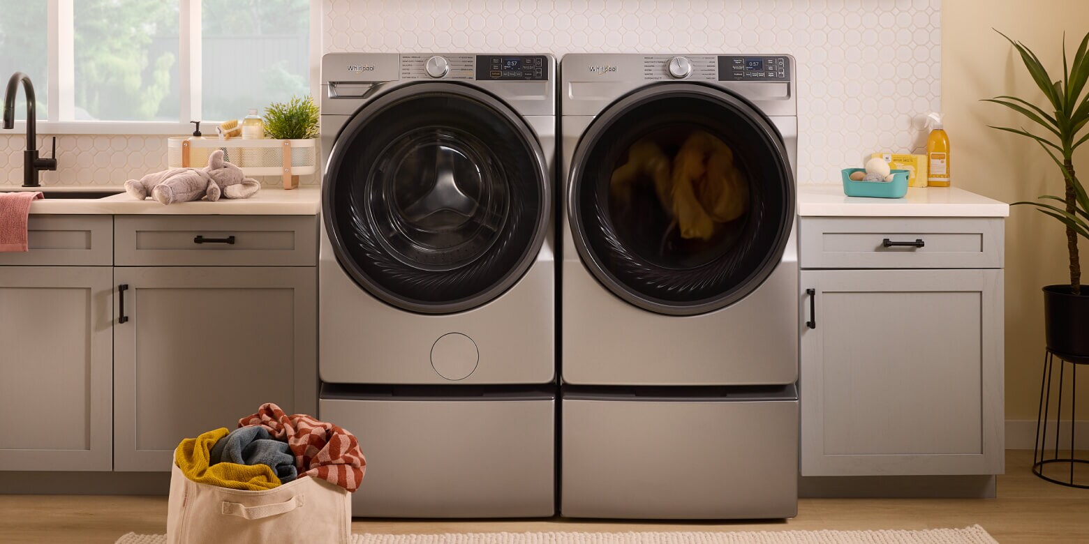 A front load washer and dryer next to each other in a modern laundry room