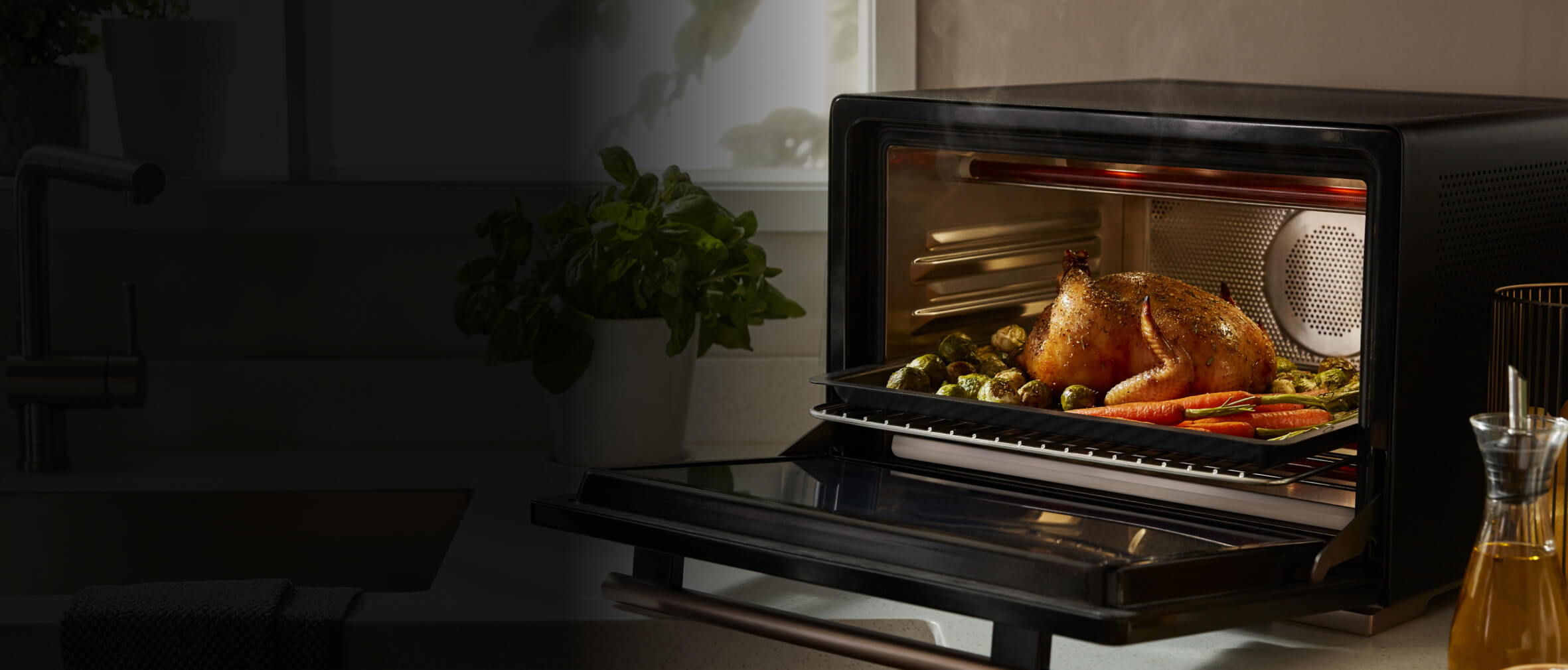 An open WLabs™ Smart Oven on a counter filled with cooked chicken and vegetables.