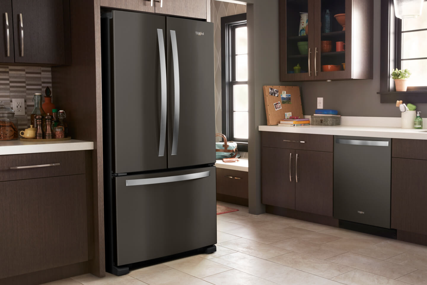 Black stainless steel Whirlpool® French Door refrigerator in a modern kitchen