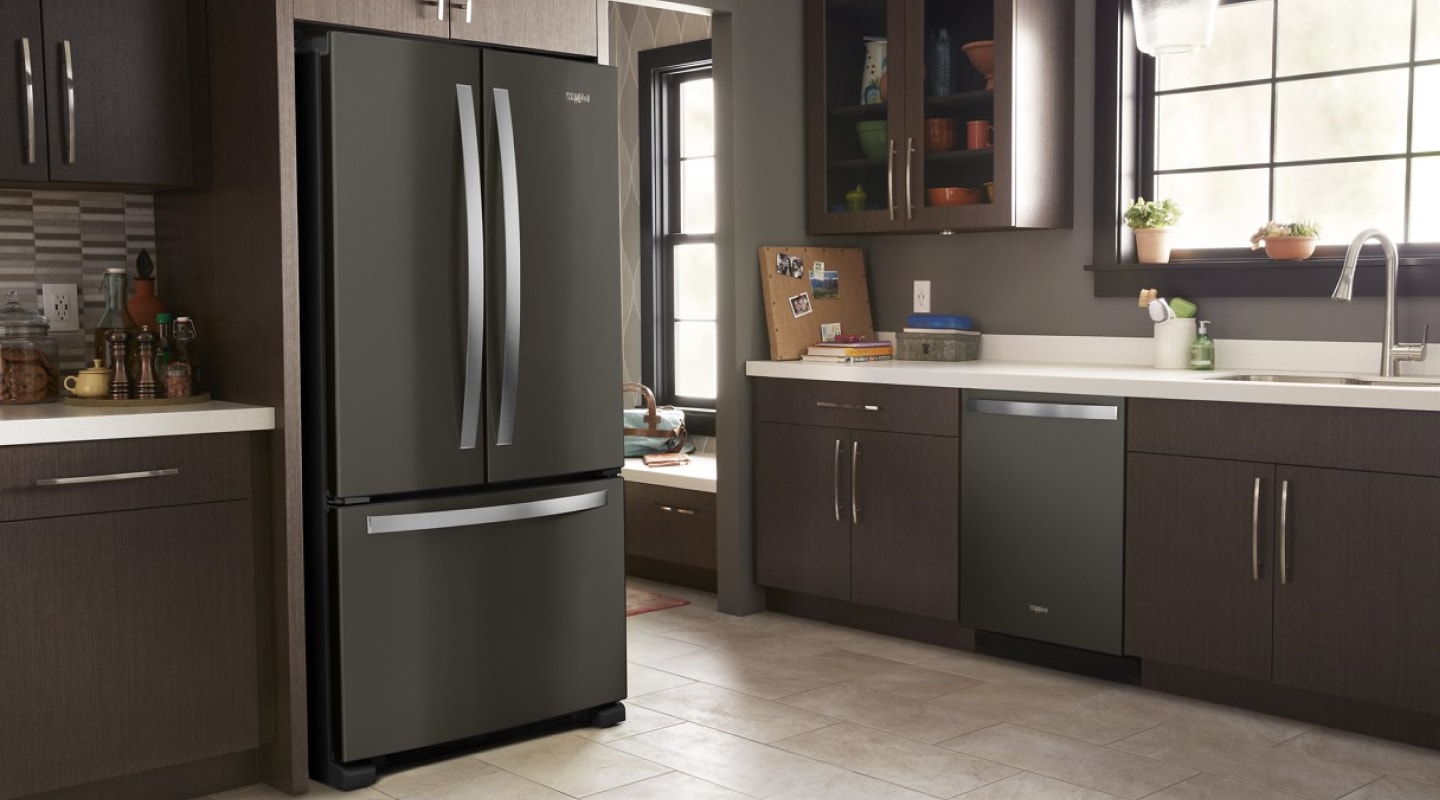 Black stainless steel Whirlpool® French Door refrigerator in a modern kitchen
