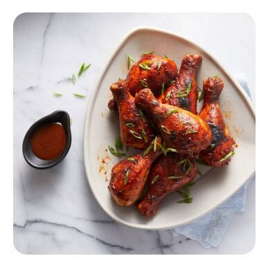 Barbecue glazed chicken legs in a white dish