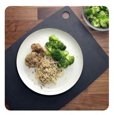 Chicken, wild rice and broccoli on a white plate