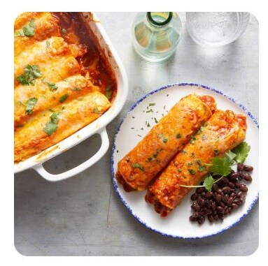 Cheesy enchiladas on a plate with black beans