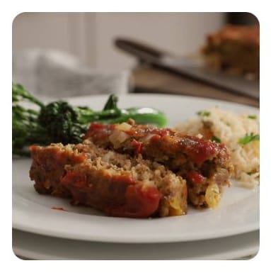 Two thick slices of meatloaf on a plate with broccoli Two thick slices of meatloaf on a plate with broccoli