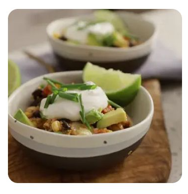 A bowl of quinoa casserole with lime and sour cream A bowl of quinoa casserole with lime and sour cream